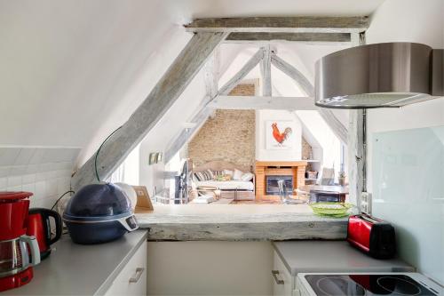 a kitchen with a counter top with a window at Le Moulin de Dannemarie in Dannemarie