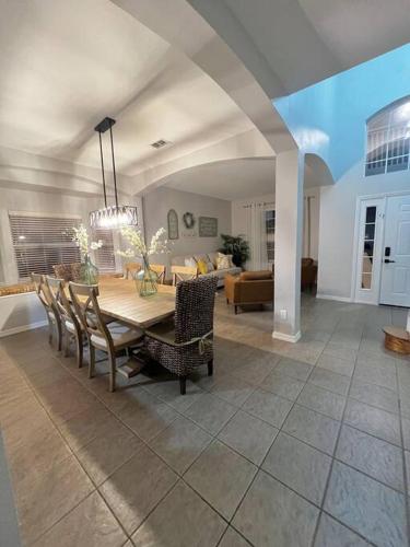 a dining room and living room with a table and chairs at Emerald Island Private Pool Home near Disney in Kissimmee