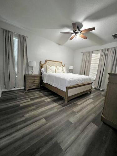 a bedroom with a bed and a ceiling fan at Emerald Island Private Pool Home near Disney in Kissimmee
