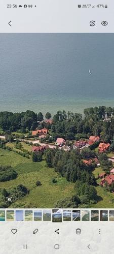 an aerial view of a town with houses and the ocean at Biały Żagiel - Dom do wynajęcia Pluski in Pluski