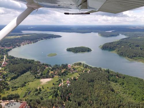 a view of a lake from an airplane at Biały Żagiel - Dom do wynajęcia Pluski in Pluski