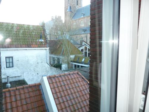 a view of a city from a window at Hotel Centraal in Harlingen