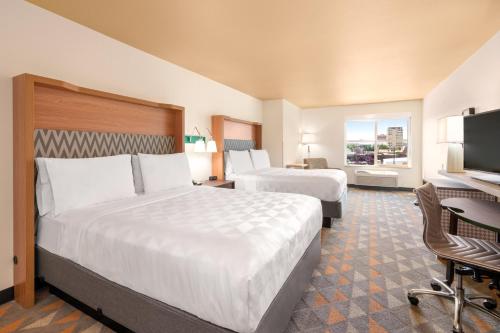 a hotel room with two beds and a television at Holiday Inn Yakima by IHG in Yakima
