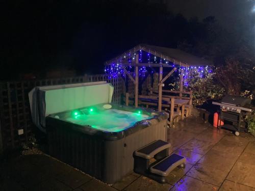 a hot tub with a gazebo with christmas lights at Loxleys Lodge in Newark upon Trent