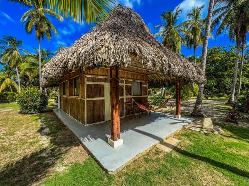 a small hut with a straw roof at Hotel Playa Bonita Tayrona in Buritaca