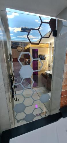 a view of a bathroom through a glass door at Design Apartment PLATINIUM SPA LUX 5 STAR "HAVANA" Completely PRIVATE Wellness & Spa FREE INCLUDED Sauna & Jacuzzi & Salt Wall & Fire place & 3D Ceilings & Business WiFi & NETFLIX & Keyless code entry & FULL SMART APP & SECURE 2 Parking place in Ćuprija