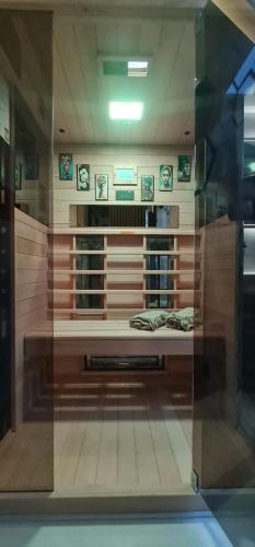 a display window of a room with a bed at Design Apartment PLATINIUM SPA LUX 5 STAR "HAVANA" Completely PRIVATE Wellness & Spa FREE INCLUDED Sauna & Jacuzzi & Salt Wall & Fire place & 3D Ceilings & Business WiFi & NETFLIX & Keyless code entry & FULL SMART APP & SECURE 2 Parking place in Ćuprija