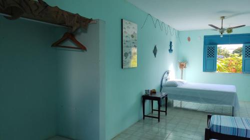 a hospital room with a bed and a window at Refúgio da Mangueira in Barra dos Coqueiros