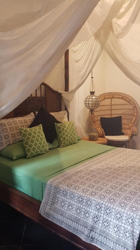 a bedroom with a bed with a canopy at Villa Jati - Private Poolside Villa Central Lovina in Lovina