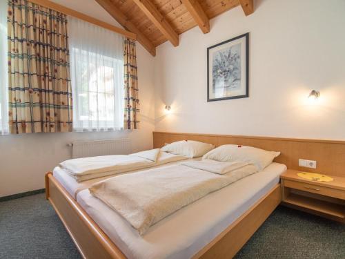 a large bed in a room with a window at Haus Irmgard 1 in Mathon