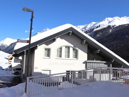 a white building with a snow covered mountain at Haus Irmgard 2 in Mathon
