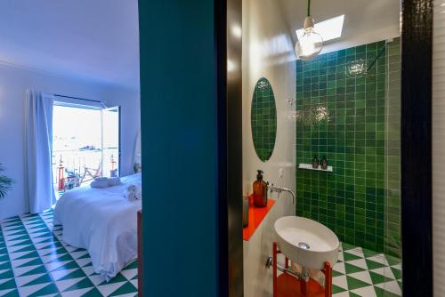 a bathroom with a bed and a green tile floor at B&B Toledo Panoramic Rooftop with terrace in Naples