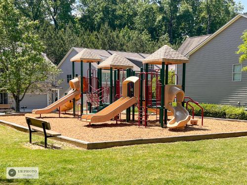 a playground with a bunch of slides in the grass at 4 - Bed home with Cali King Bed, 12 mins to DTWN in Atlanta