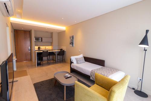 a living room with a bed and a couch and a table at Hotel Treinta-Seis in Mar del Plata