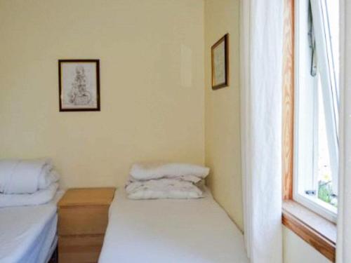 a room with two beds and a window at 4 person holiday home in MÅLØY-By Traum in Måløy