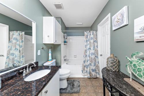 a bathroom with a sink and a toilet at Cozy budget friendly condo close to the beach in Gulf Shores