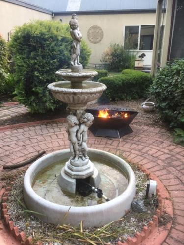 a fountain in the middle of a brick yard at Tranquilles Bed & Breakfast in Port Sorell