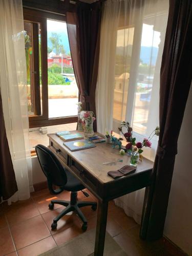 a wooden desk with a chair and a window at Colonial Charm in Antigua - women only in Antigua Guatemala