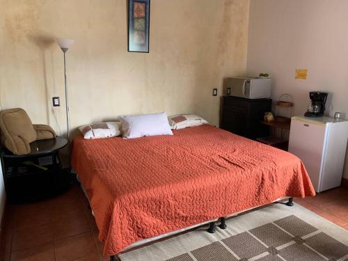 a bedroom with a bed with a red blanket at Colonial Charm in Antigua - women only in Antigua Guatemala