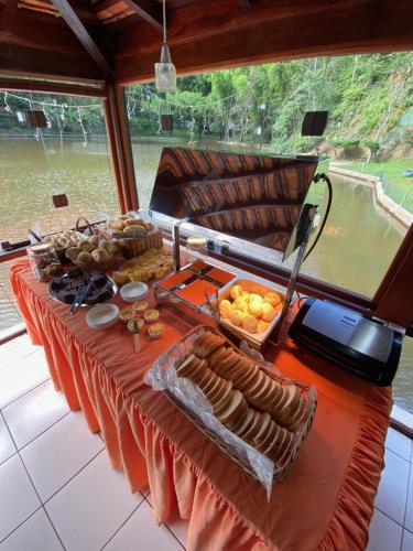 a table on a boat with food on it at Hotel Fazenda Bonanza in Engenheiro Paulo de Frontin
