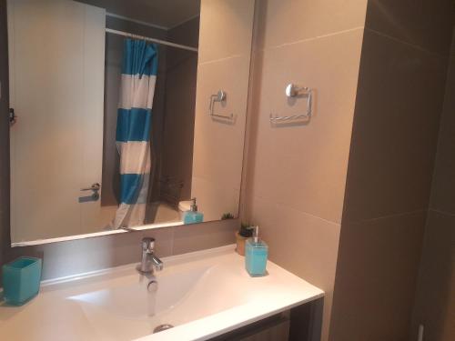 a bathroom with a sink and a mirror at laguna del mar, la serena in La Serena