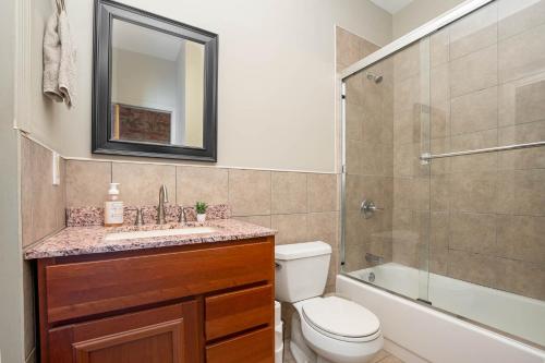 a bathroom with a toilet and a sink and a shower at The Reserve - Heart of OTR 2 Bed Suite w/Views in Cincinnati