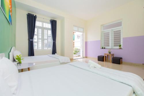 a large bedroom with two beds and a window at Villa Vũng Tàu - An Thảo Home's in Vung Tau