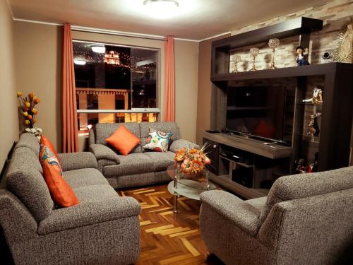 Una sala de estar con dos sofás y una chimenea. en PRIVATE APARTMENT IN THE HISTORICAL CENTER OF CUSCO, en Cusco