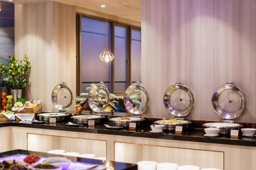 a buffet line with plates of food on a table at Fifth Pattaya Jomtien By Shiwalai Int in Jomtien Beach