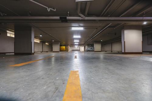 an empty parking garage with a yellow line on the floor at Fifth Pattaya Jomtien By Shiwalai Int in Jomtien Beach