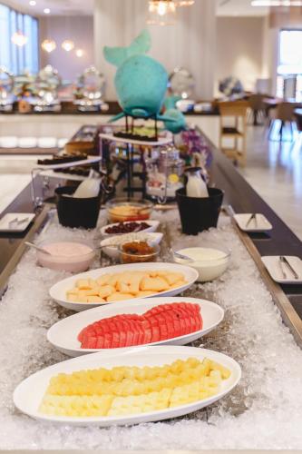 a buffet with plates of food on a table at Fifth Pattaya Jomtien By Shiwalai Int in Jomtien Beach