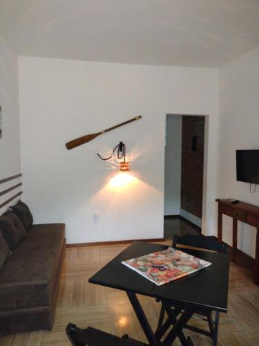a living room with a couch and a table at Saquaflats in Saquarema