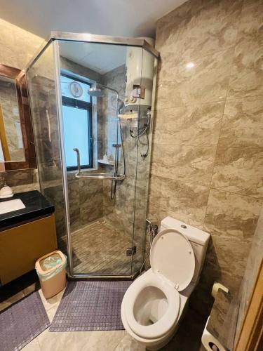 a bathroom with a toilet and a glass shower at R&F PRINCESS COVE at ANJU in Johor Bahru