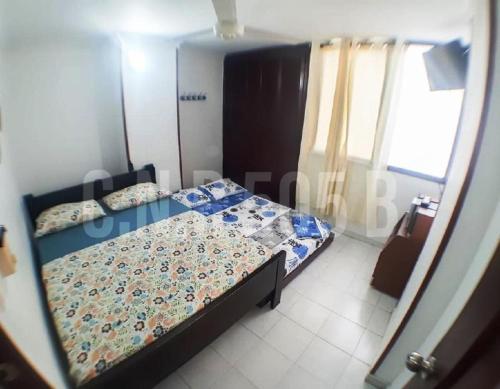 a bedroom with a bed in a room at Condominio Nuevo Rodadero, wifi piscina parqueadero in Santa Marta