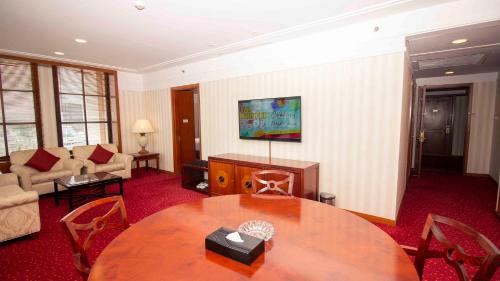 a living room with a table and a couch at Redtop Hotel & Convention Center in Jakarta