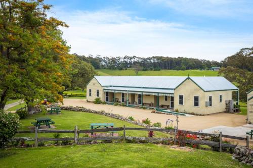 an aerial view of a farm house with a fence at Henkley Cottage 3 Ezekiel in Central Tilba