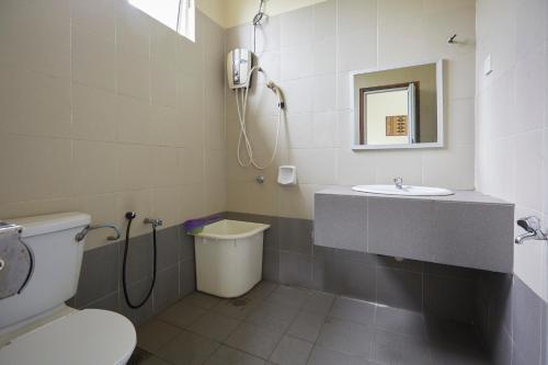 a bathroom with a toilet and a sink at Terengganu Equestrian Resort in Kuala Terengganu