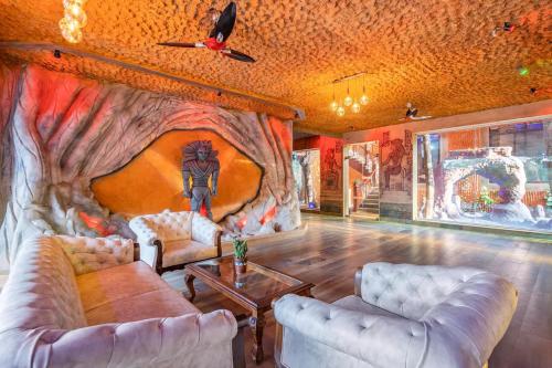 a living room with a painting on the wall at Shivaaz Villa - Celebrity 4BHK Luxury Villa in Goa with Private Pool in Porvorim