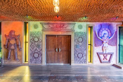 a room with a door with paintings on the wall at Shivaaz Villa - Celebrity 4BHK Luxury Villa in Goa with Private Pool in Porvorim