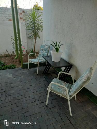 two chairs and a table on a patio at Kea bed and breakfast in Mogwase