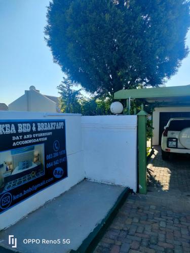 a car parked in a driveway next to a white wall at Kea bed and breakfast in Mogwase