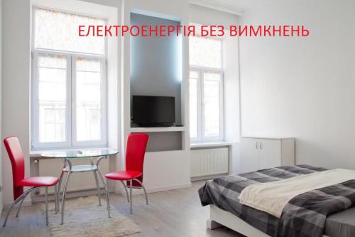 リヴィウにあるApartment in the centre of Lvivのベッドルーム1室(ベッド1台、テーブル、椅子付)