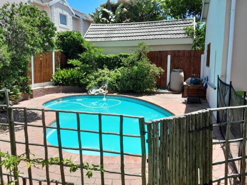 a small swimming pool with a fence around it at Dorset Cottage in Cape Town