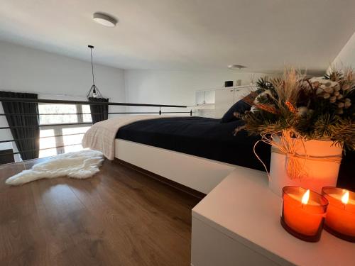 a bedroom with a bed and two candles on a table at The View - ski to door in Bjelašnica