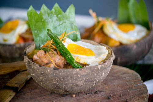 a bowl of food with eggs on a table at Maayo San Remigio in San Remigio