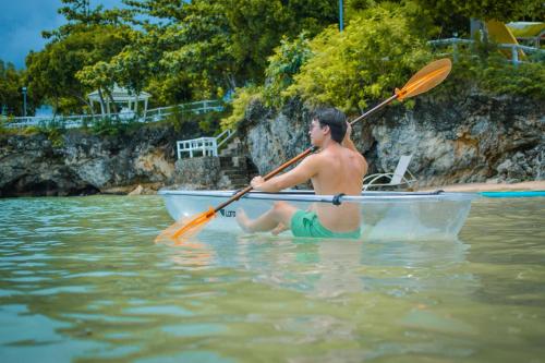a man sitting in a boat in the water at Maayo San Remigio in San Remigio