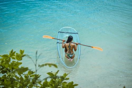 a woman is in a kayak in the water at Maayo San Remigio in San Remigio