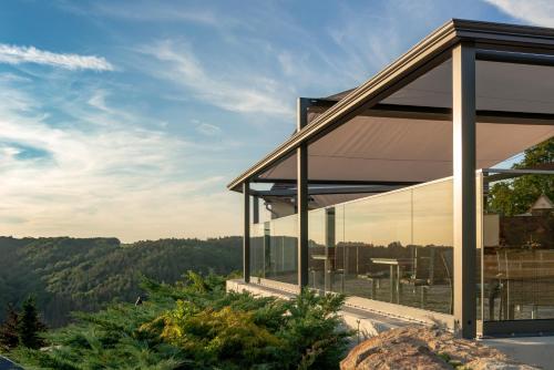 a house with a view of the mountains at Hotel Zur Aussicht in Hohnstein