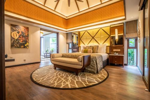 a bedroom with a bed and a chair in a room at The Banjaran Hotsprings Retreat in Ipoh