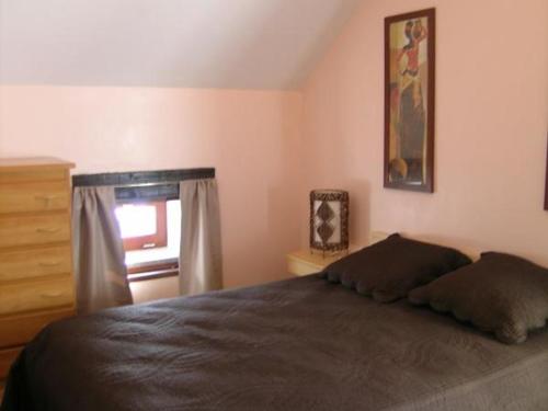 a bedroom with a bed and a dresser and a window at Gîte Saint-Sauvier, 3 pièces, 6 personnes - FR-1-489-404 